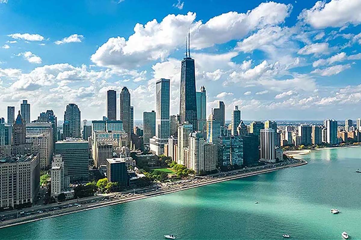 A group of men an women dressed in white outfits on the top deck of a charter yacht in Chicago IL