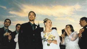 A wedding couple under a dusk sky on a charter yacht in Chicago