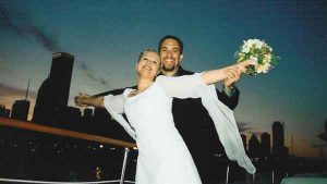 A wedding couple posing like Leonardo di Caprio and Claire Danes on a Chicago yacht charter like Titanic